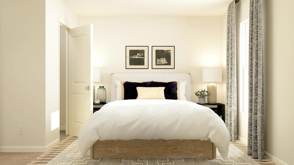 A bedroom with a bed and lamps.