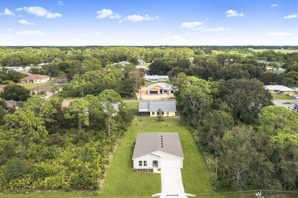 A group of houses surrounded by trees.
