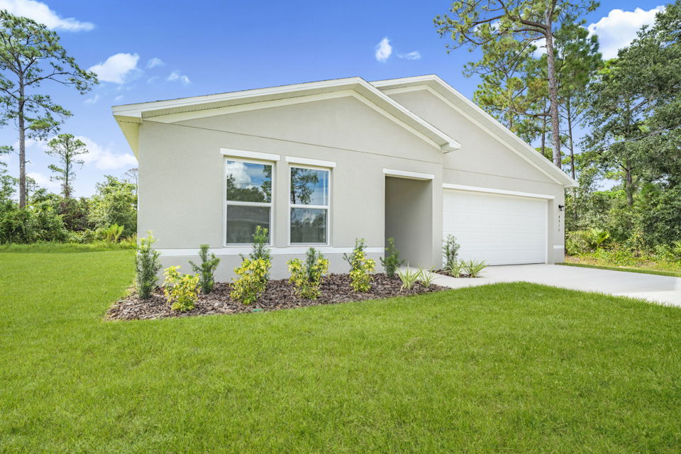 A house with a lawn and trees.