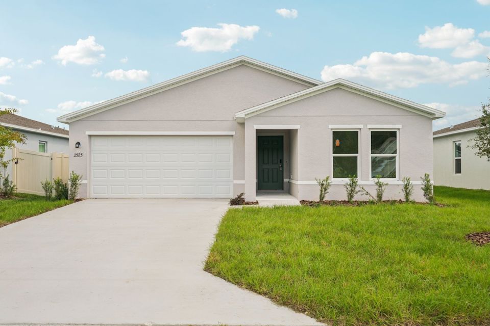 A white house with a garage.