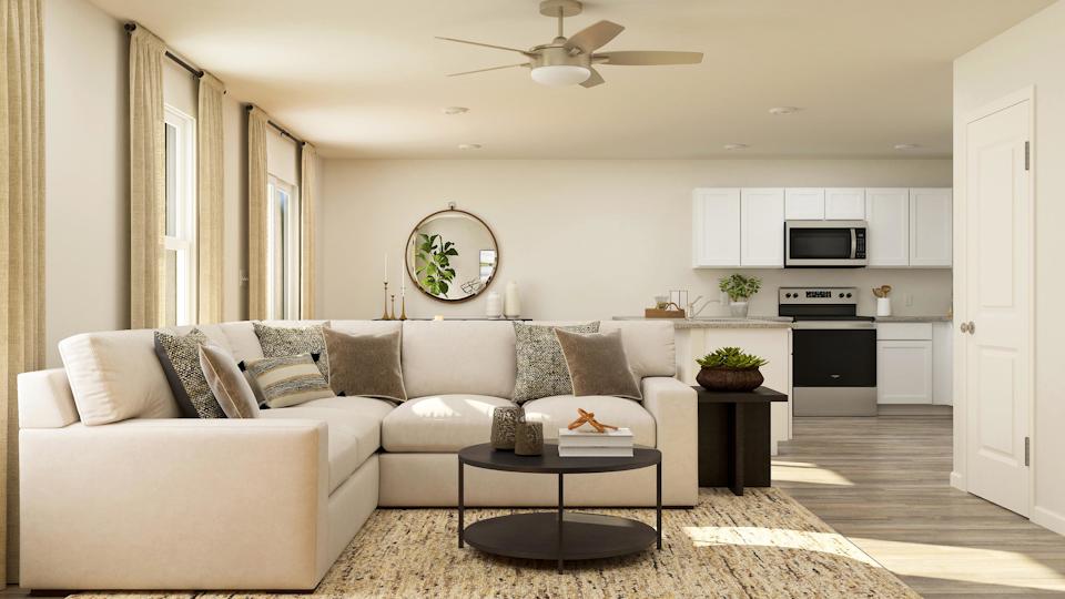 A living room with a white couch and a table.
