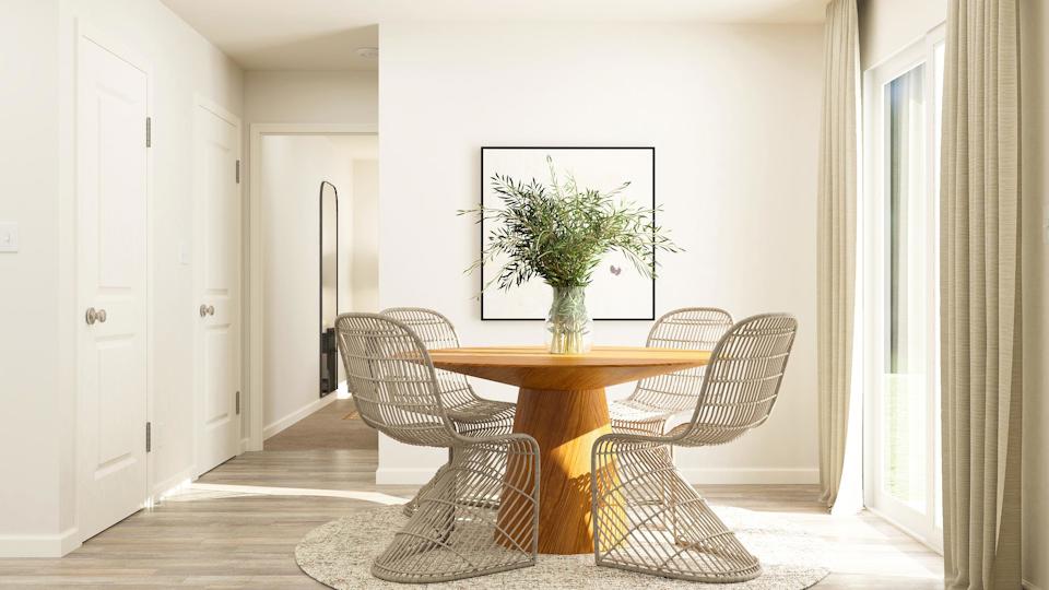 A dining room table with chairs.