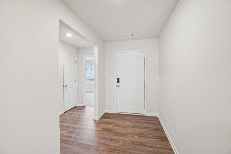A hallway with white doors.