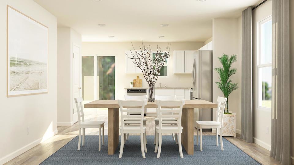 A dining room with a table and chairs.